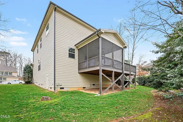 a view of an empty room with wooden floor and a large window