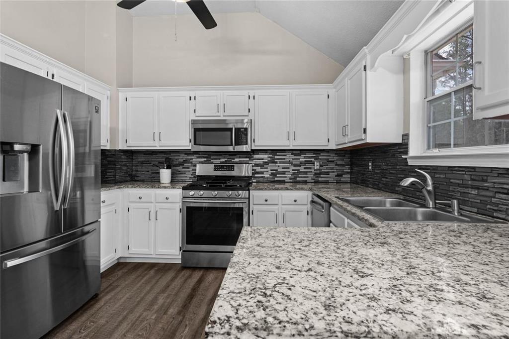 304 Ridge Hill Circle Canton, GA 30115 - Photo 14 of 42 a kitchen with stainless steel appliances granite countertop a sink stove microwave and refrigerator