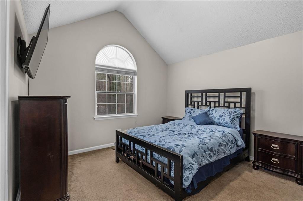 304 Ridge Hill Circle Canton, GA 30115 - Photo 17 of 42 a bedroom with a bed window and a flat screen tv