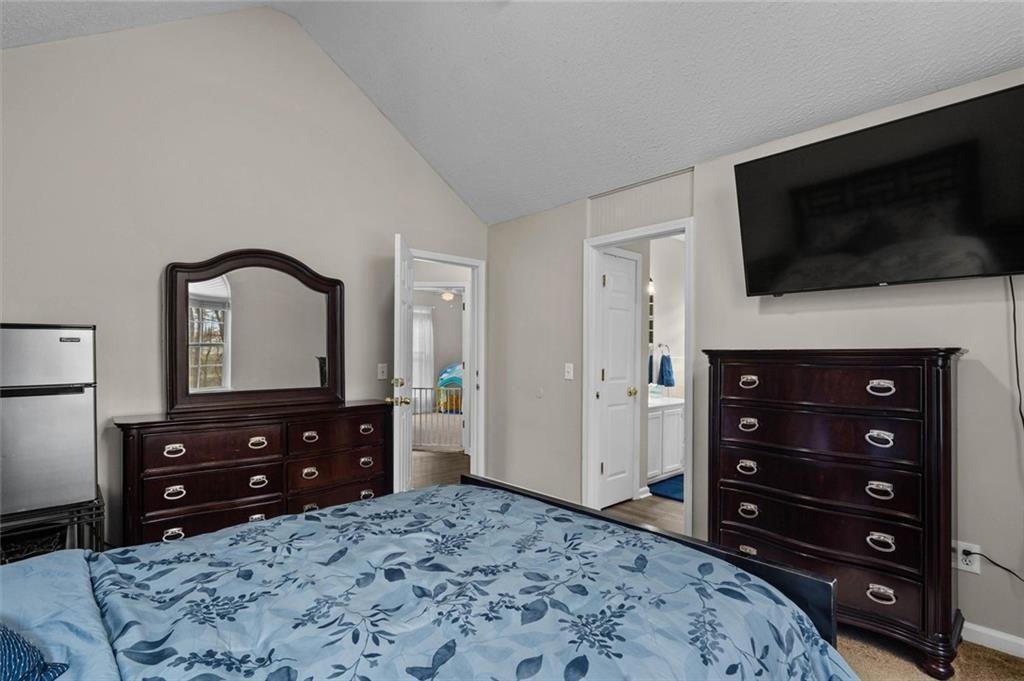 304 Ridge Hill Circle Canton, GA 30115 - Photo 18 of 42 a bedroom with a bed and a television