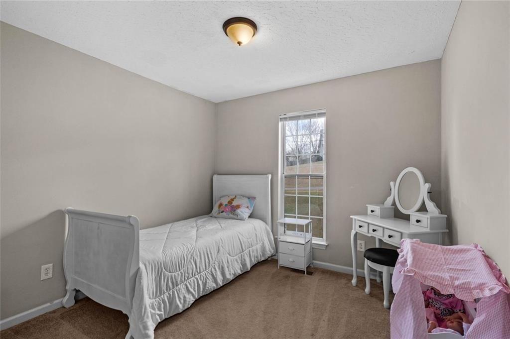 304 Ridge Hill Circle Canton, GA 30115 - Photo 21 of 42 a bedroom with a bed and a window