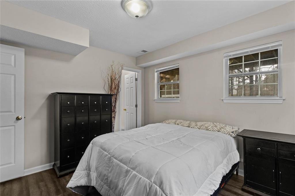 304 Ridge Hill Circle Canton, GA 30115 - Photo 26 of 42 a bedroom with a bed and wooden floor