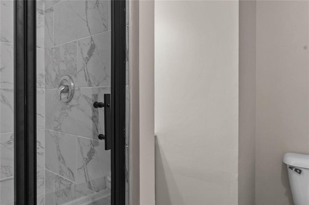 304 Ridge Hill Circle Canton, GA 30115 - Photo 27 of 42 a bathroom with a glass shower door