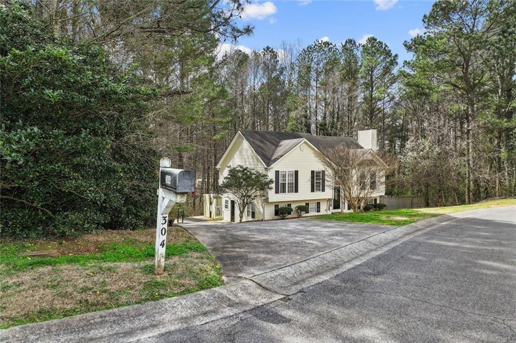 304 Ridge Hill Circle Canton, GA 30115 - Photo 39 of 42 a front view of a house with a yard and trees