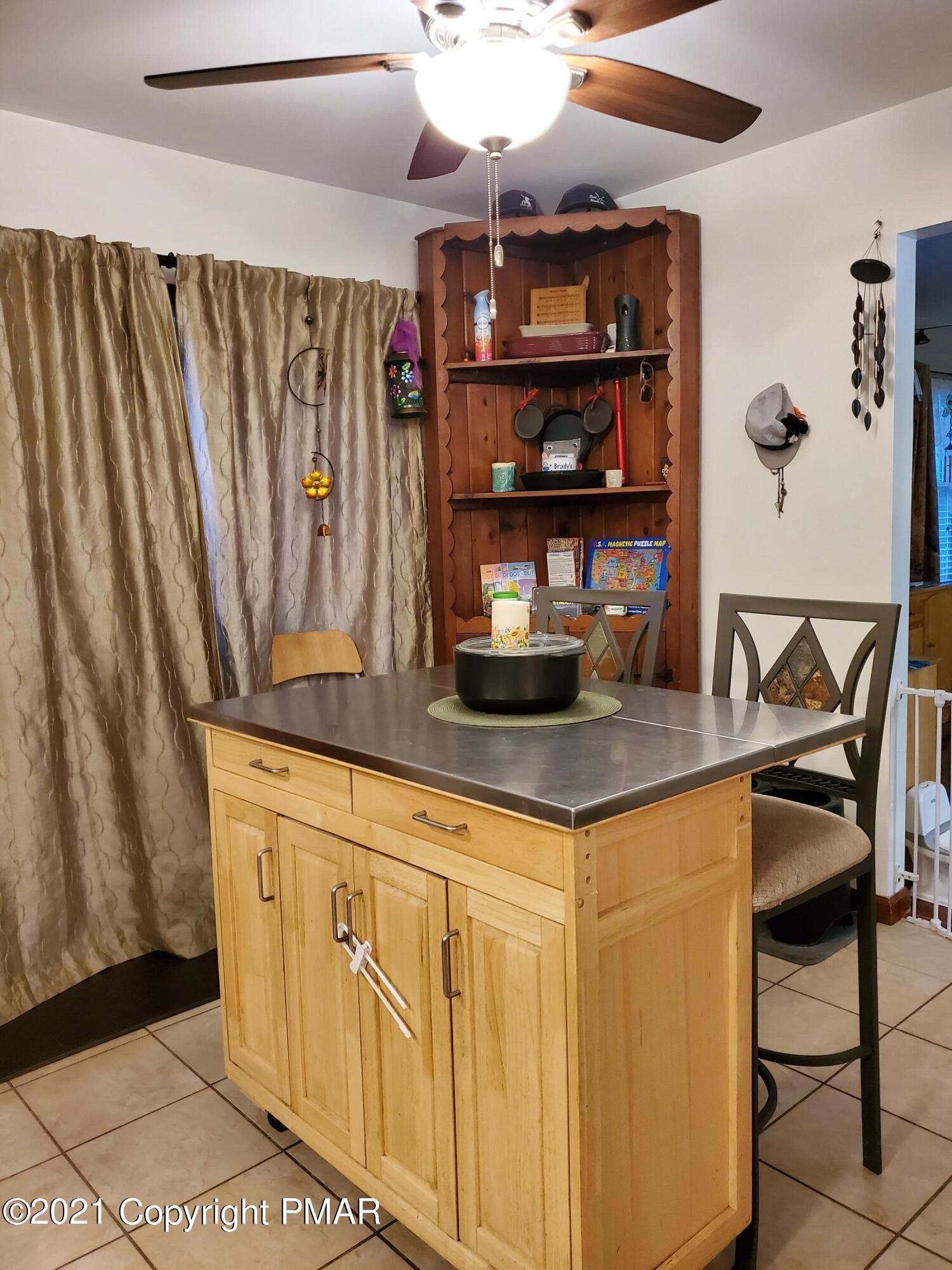 590 Henry's Crossing Road Cresco, PA 18326 - Photo 12 of 31 a kitchen with stainless steel appliances granite countertop a sink and cabinets