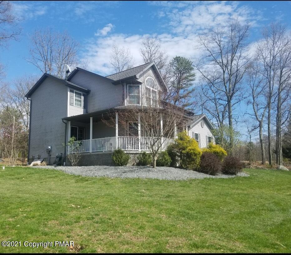 590 Henry's Crossing Road Cresco, PA 18326 - Photo 2 of 31 a front view of a house with garden