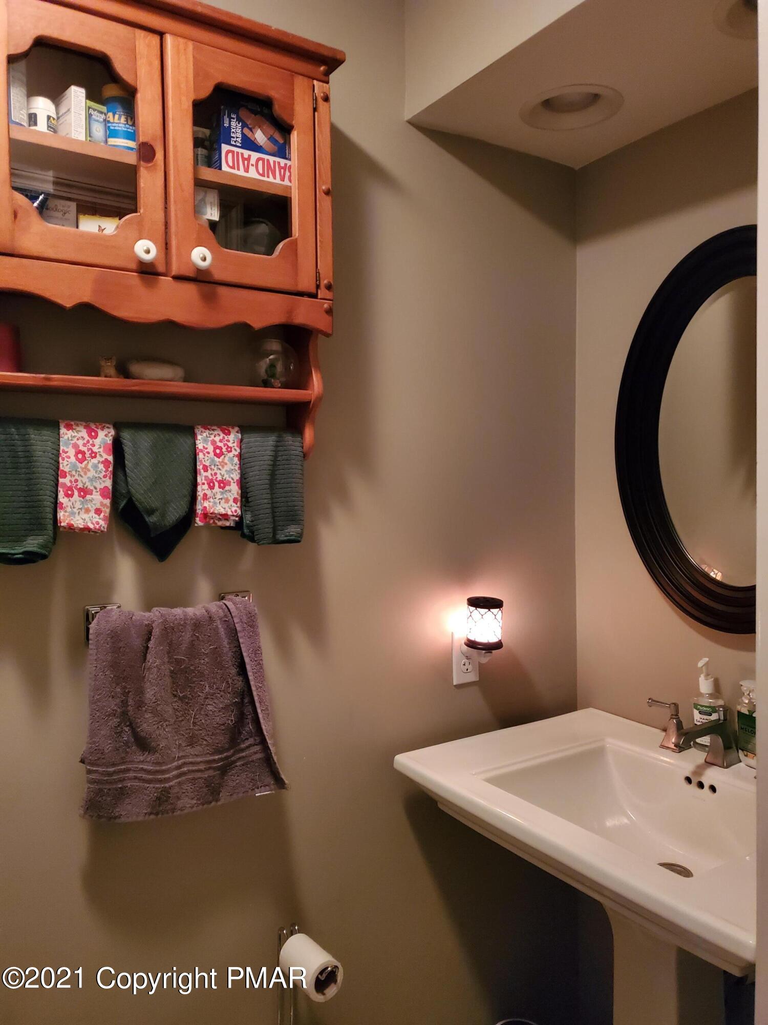 590 Henry's Crossing Road Cresco, PA 18326 - Photo 22 of 31 a bathroom with a sink and a mirror