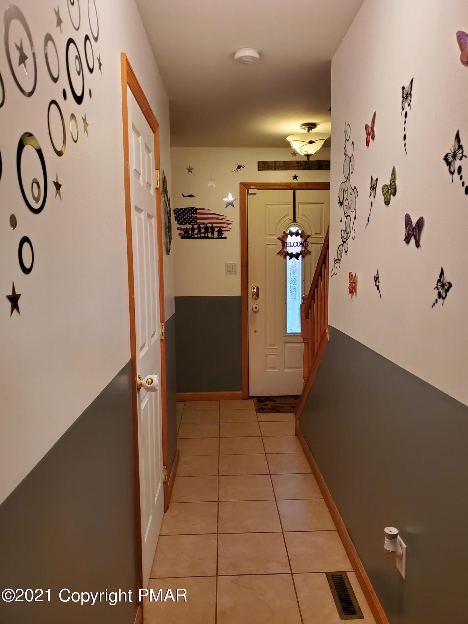 590 Henry's Crossing Road Cresco, PA 18326 - Photo 23 of 31 a view of hallway with stairs and a refrigerator