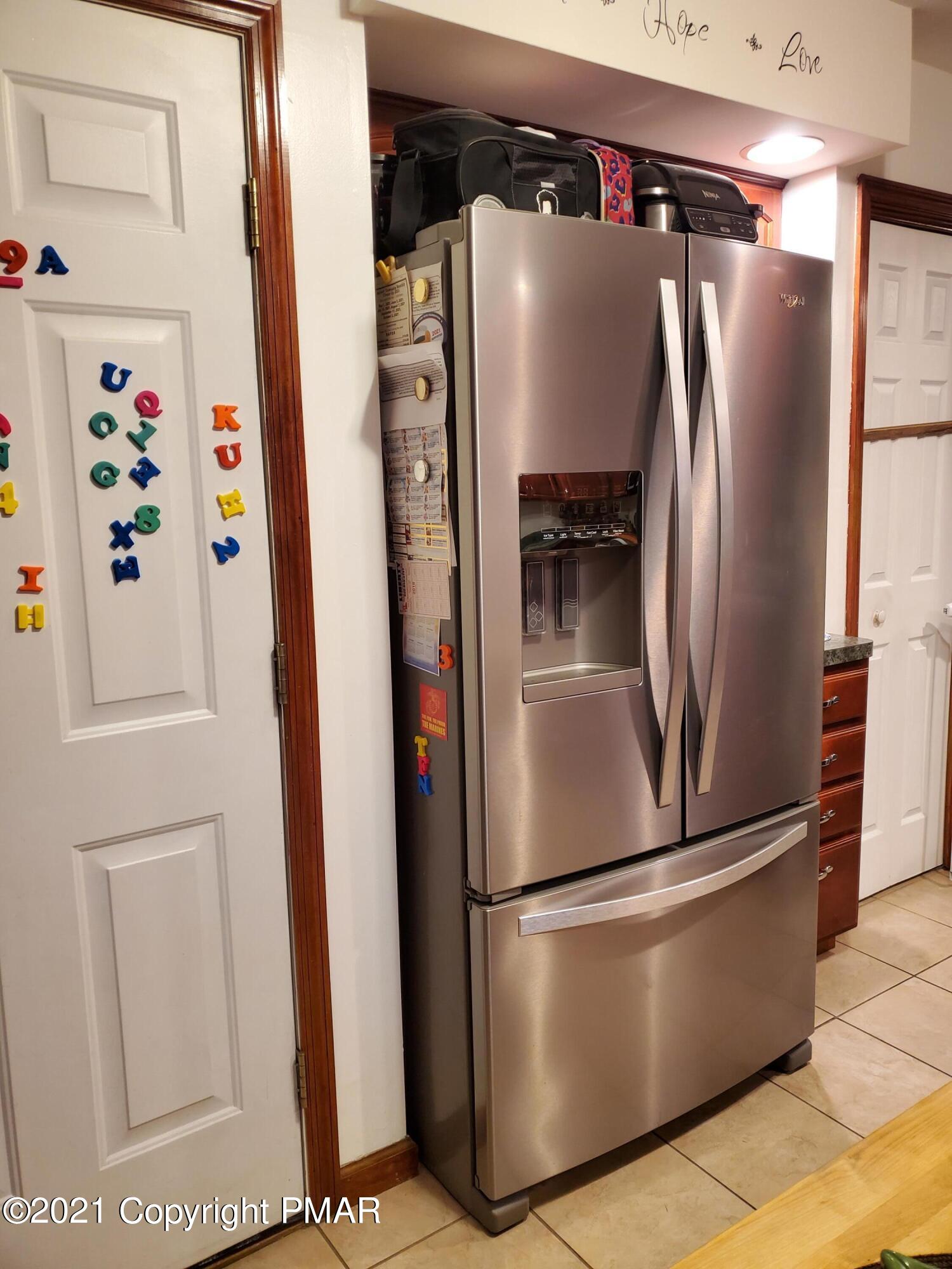 590 Henry's Crossing Road Cresco, PA 18326 - Photo 24 of 31 a metallic refrigerator freezer sitting in a kitchen