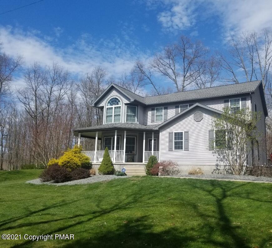 590 Henry's Crossing Road Cresco, PA 18326 - Photo 3 of 31 a front view of a house with a garden