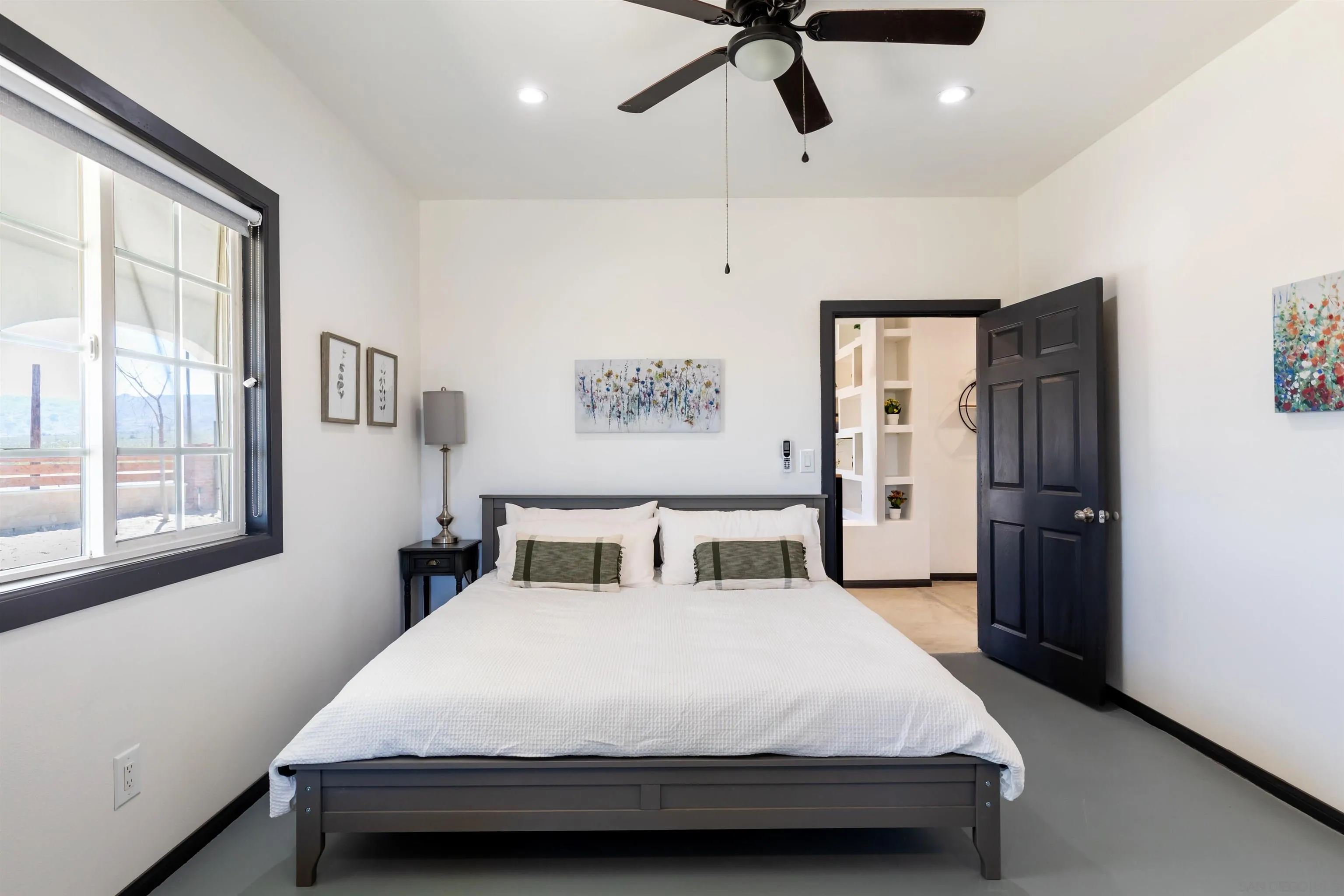 5066 Lear Avenue Twentynine Palms, CA 92277 - Photo 15 of 69 a bedroom with a large bed and a chandelier