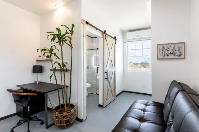 a bedroom with a bed and a lamp