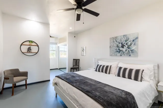 a bedroom with bed and a chair