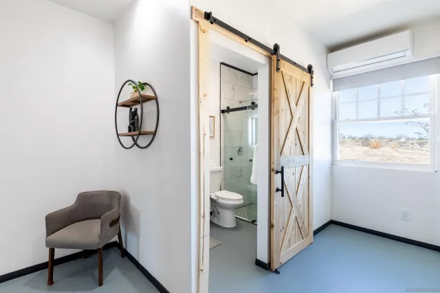 a bathroom with a sink mirror vanity and toilet