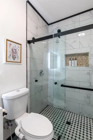 a bedroom with two beds and painting on the wall