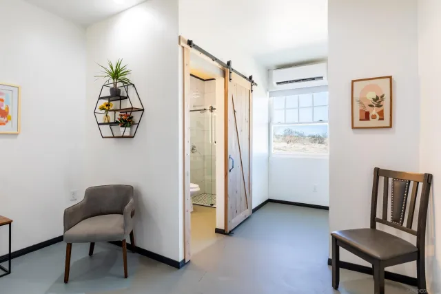a bathroom with a toilet sink a mirror a shower and vanity