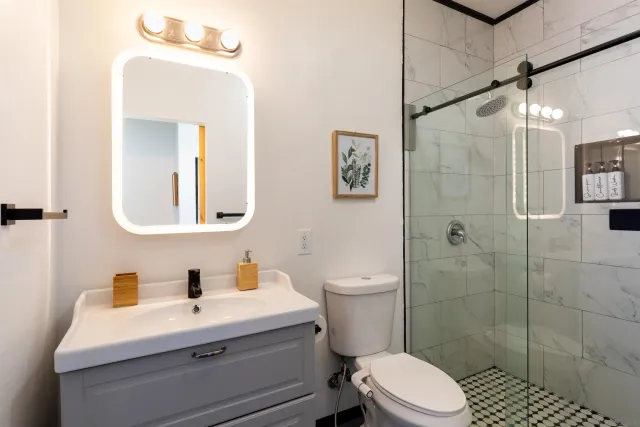 a bathroom with a toilet a sink and shower