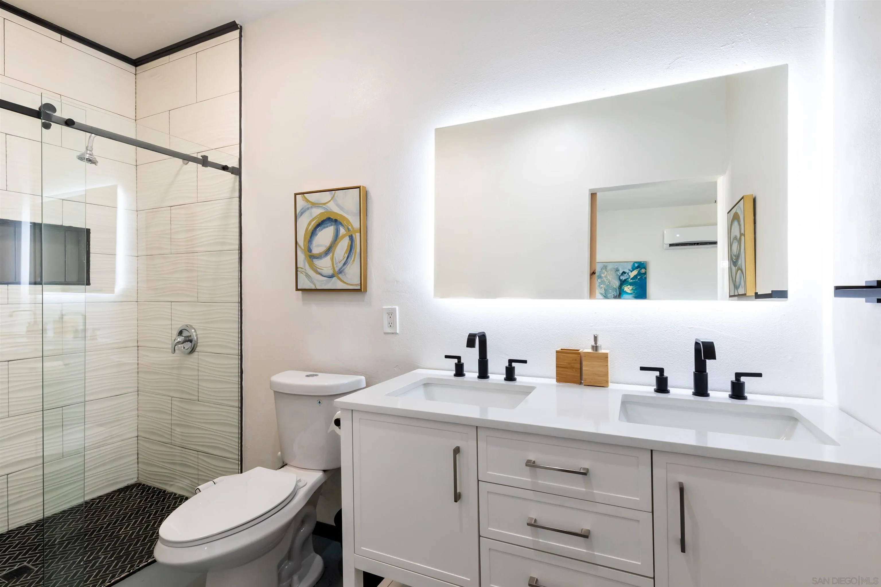 5066 Lear Avenue Twentynine Palms, CA 92277 - Photo 41 of 69 a bathroom with a toilet sink a mirror a shower and vanity