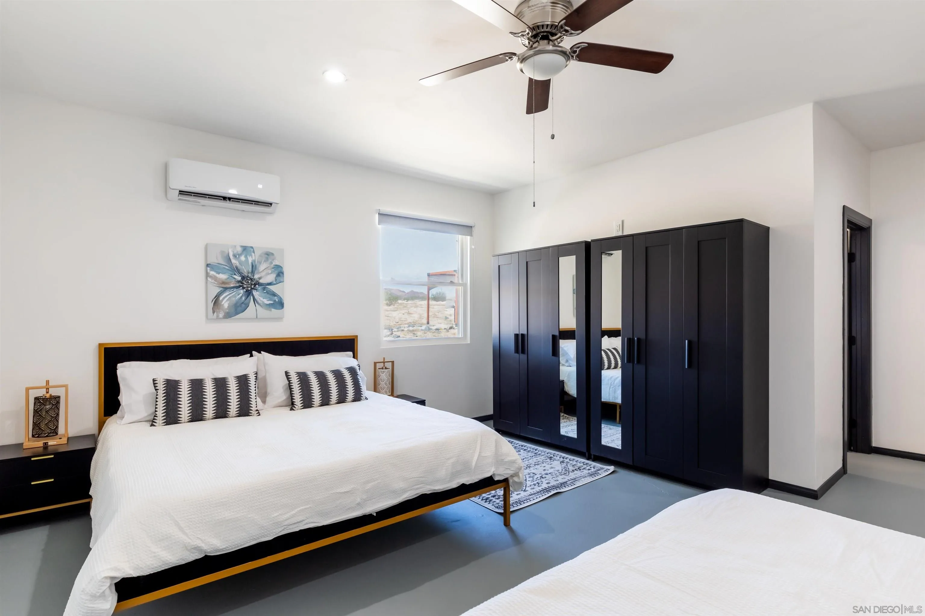 5066 Lear Avenue Twentynine Palms, CA 92277 - Photo 46 of 69 a bedroom with a large bed and a chandelier