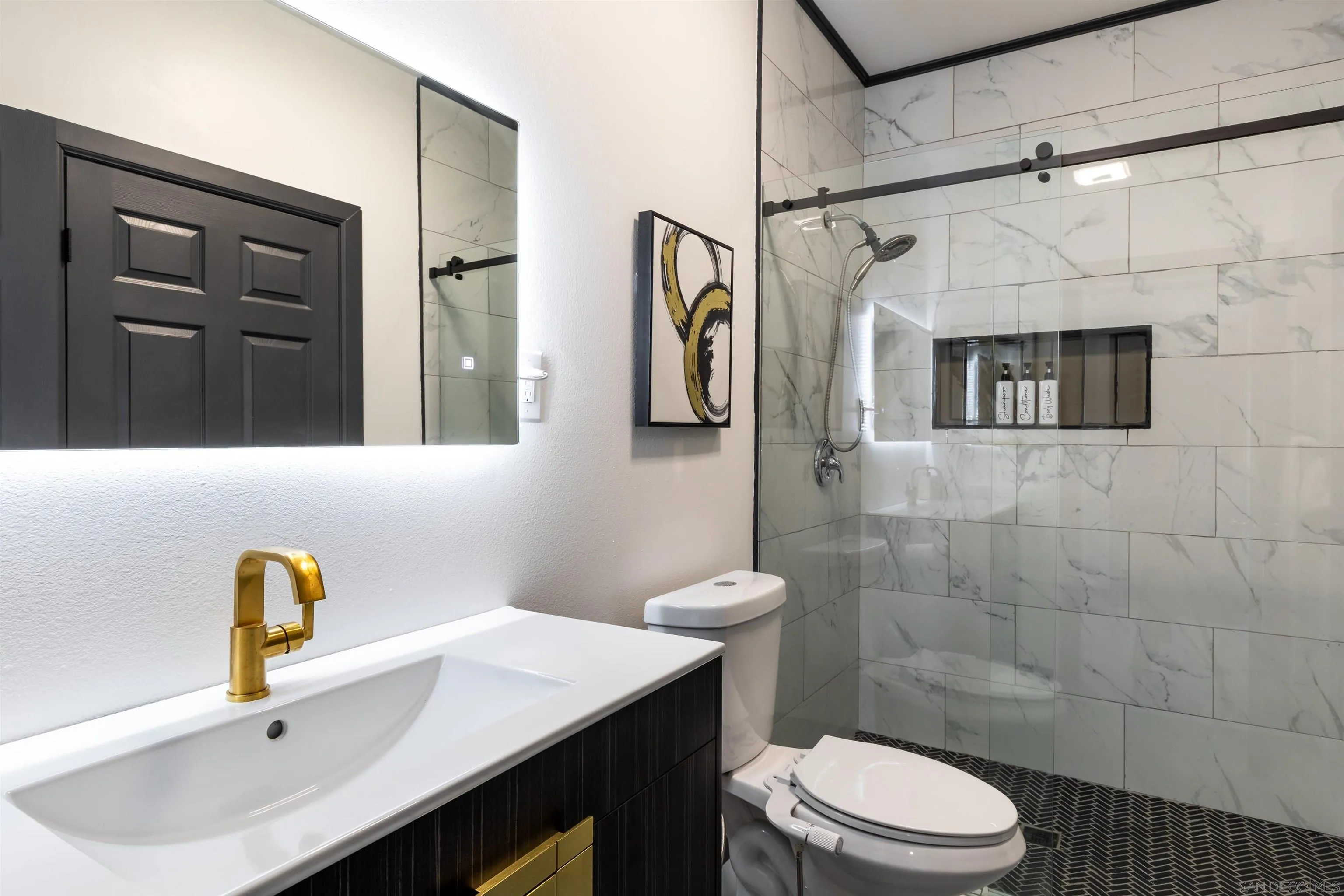 5066 Lear Avenue Twentynine Palms, CA 92277 - Photo 50 of 69 a bathroom with a sink toilet a mirror and shower