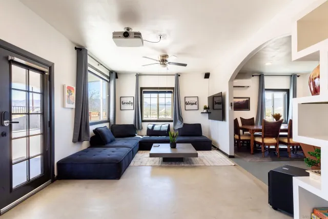 a living room with furniture and a chandelier