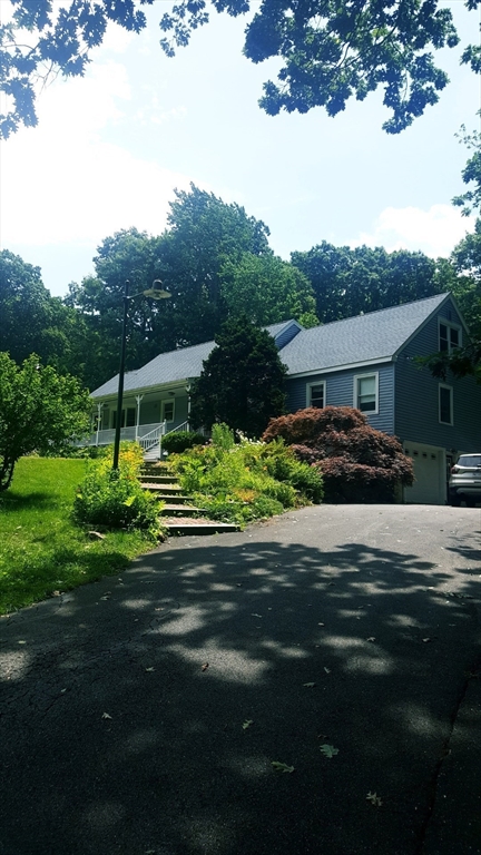 222 Edson Road Oakham, MA 01068 - Photo 2 of 31 a front view of a house with a garden