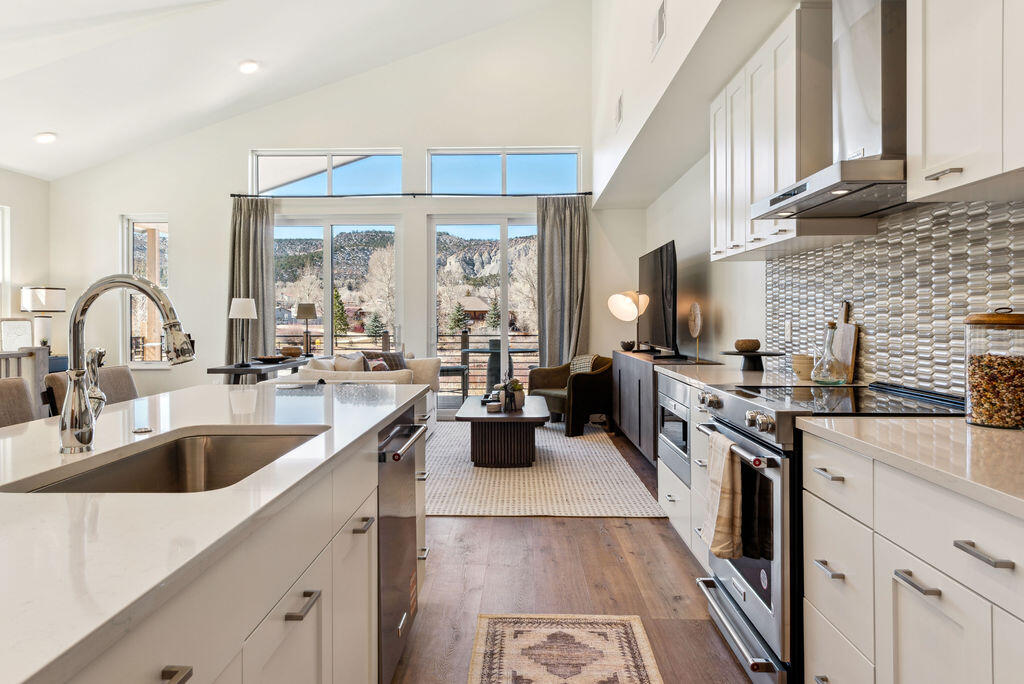 176 Alpine Lane, Unit 300 M2 301 Ridgway, CO 81432 - Photo 30 of 37 a kitchen with sink a stove and cabinets