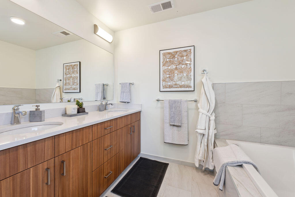 176 Alpine Lane, Unit 300 M2 301 Ridgway, CO 81432 - Photo 32 of 37 a bathroom with a double vanity sink a mirror and a bathtub