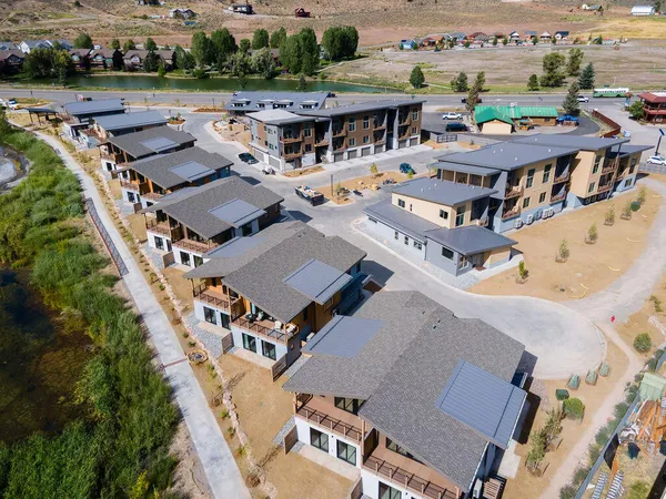 an aerial view of a house with a yard garage and lake view