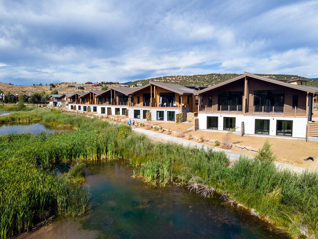 176 Alpine Lane, Unit 300 M2 301 Ridgway, CO 81432 - Photo 8 of 37 a view of a big house with a big yard and large trees