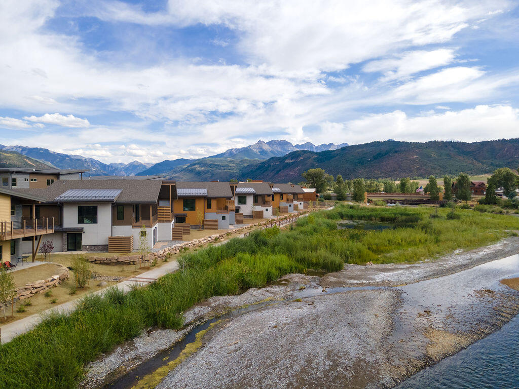 176 Alpine Lane, Unit 300 M2 301 Ridgway, CO 81432 - Photo 9 of 37 front view of a house with a yard