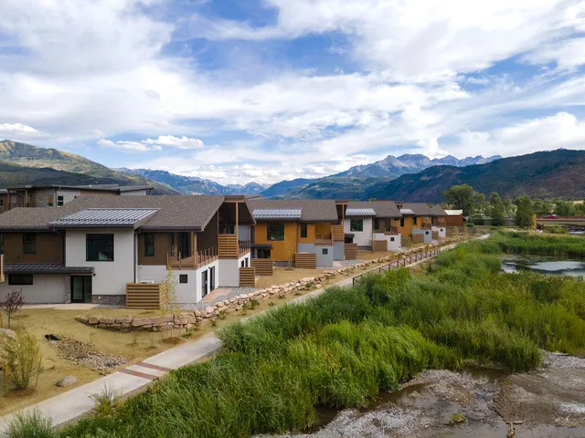 a front view of a house with a yard table and chairs