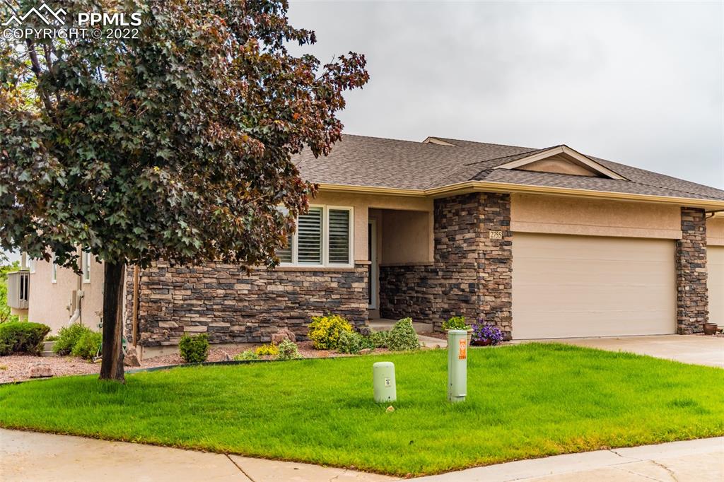 2755 Quail Ridge Point Colorado Springs, CO 80906 - Photo 1 of 35 a front view of a house with garden