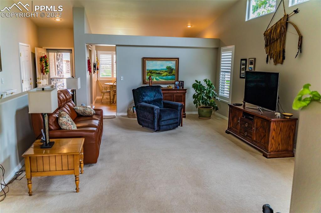 2755 Quail Ridge Point Colorado Springs, CO 80906 - Photo 11 of 35 a living room with furniture and a flat screen tv