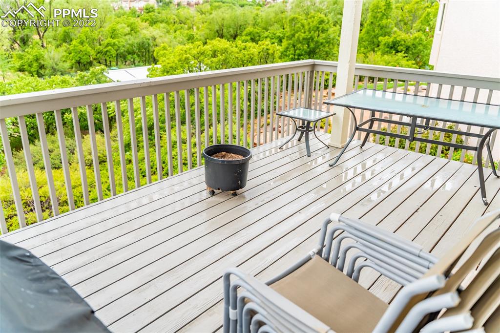 2755 Quail Ridge Point Colorado Springs, CO 80906 - Photo 14 of 35 a view of a deck with wooden floor and outdoor seating