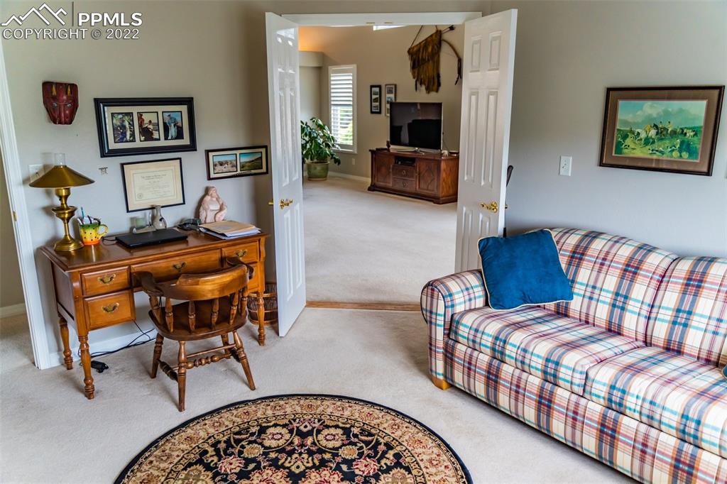 2755 Quail Ridge Point Colorado Springs, CO 80906 - Photo 19 of 35 a bedroom with furniture and a wooden floor