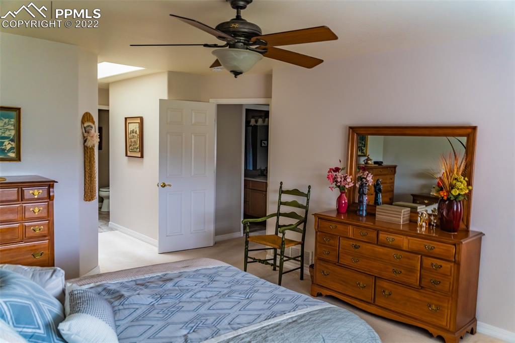 2755 Quail Ridge Point Colorado Springs, CO 80906 - Photo 22 of 35 a bedroom with furniture and a mirror