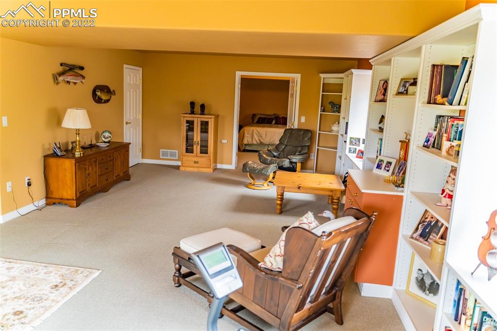 2755 Quail Ridge Point Colorado Springs, CO 80906 - Photo 29 of 35 a living room with furniture and a flat screen tv