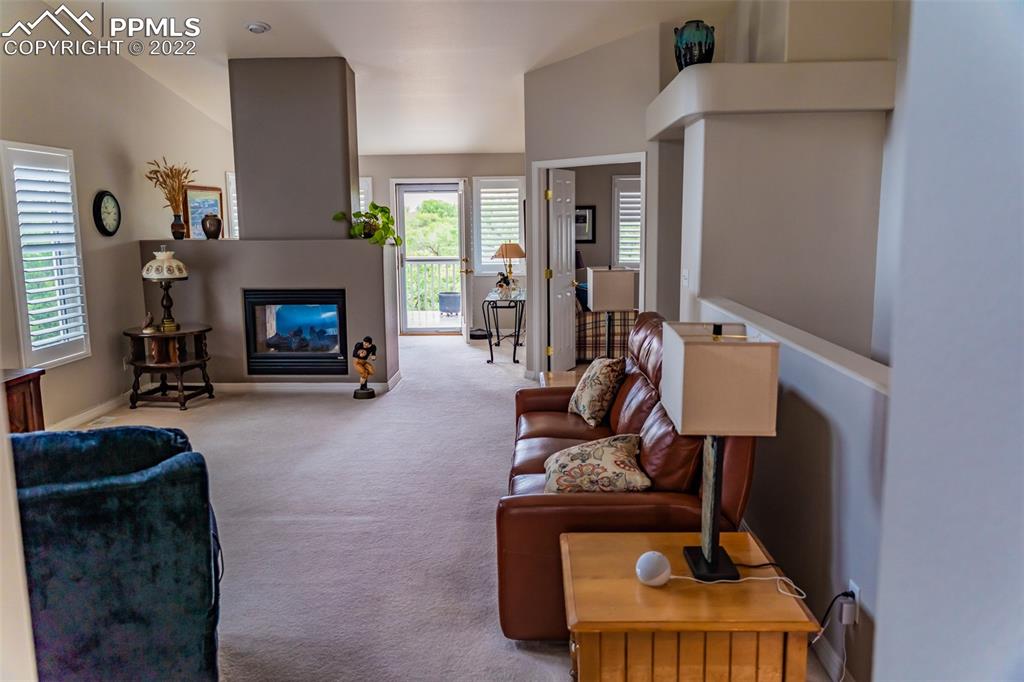 2755 Quail Ridge Point Colorado Springs, CO 80906 - Photo 9 of 35 a living room with furniture and a fireplace