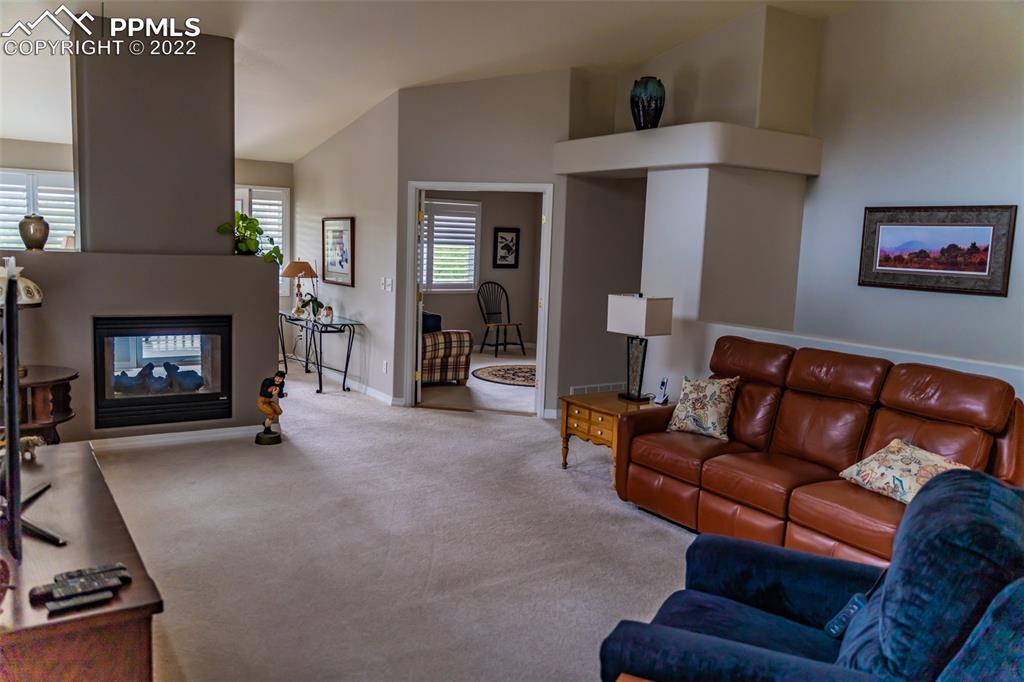 2755 Quail Ridge Point Colorado Springs, CO 80906 - Photo 10 of 35 a living room with furniture and a fireplace