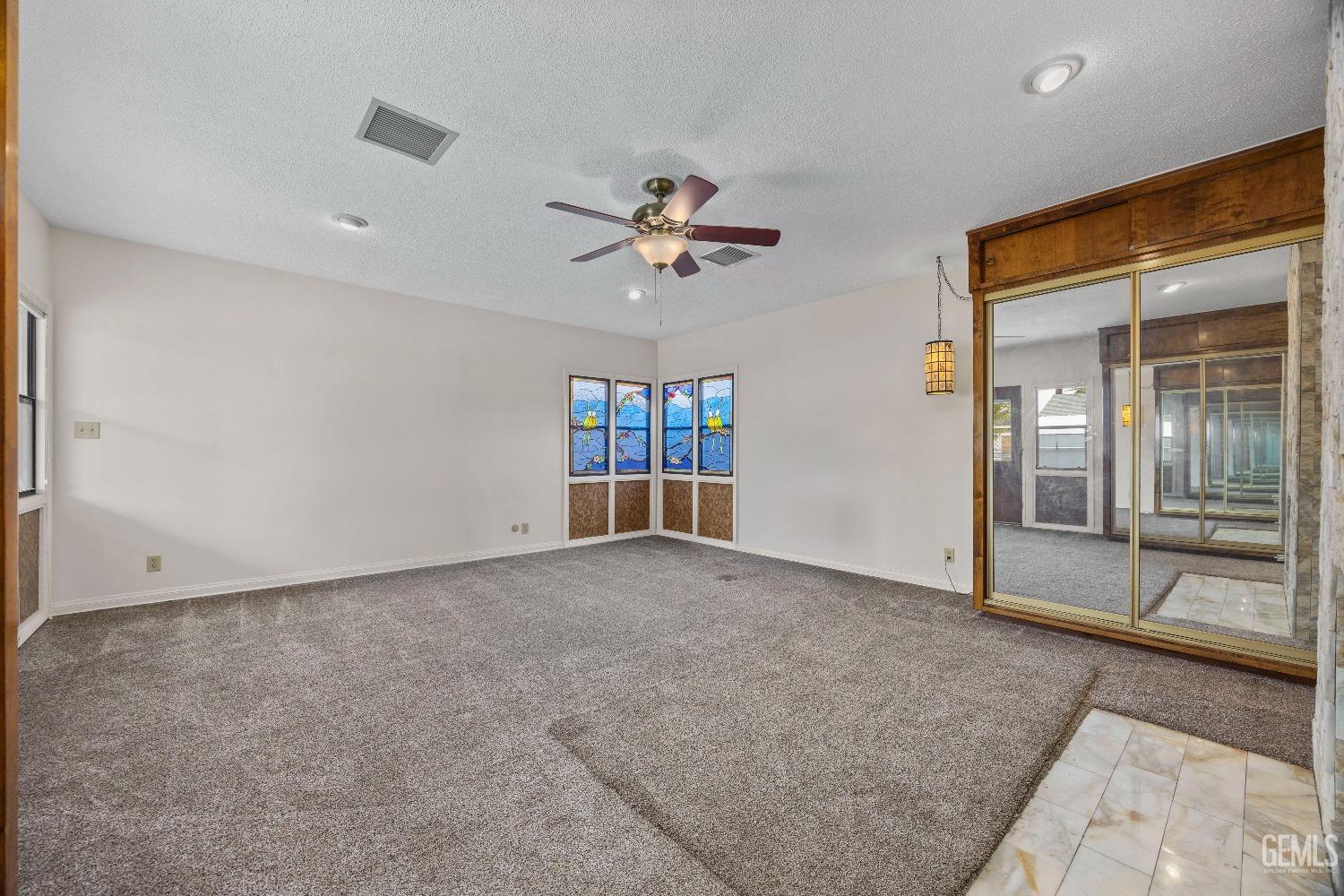 Undisclosed Address Bakersfield, CA 93308 - Photo 11 of 36 an empty room with fan and windows