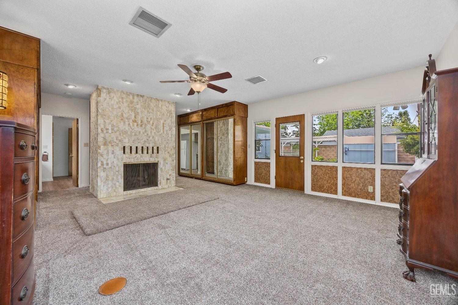 Undisclosed Address Bakersfield, CA 93308 - Photo 12 of 36 a view of an empty room with a fireplace and a window