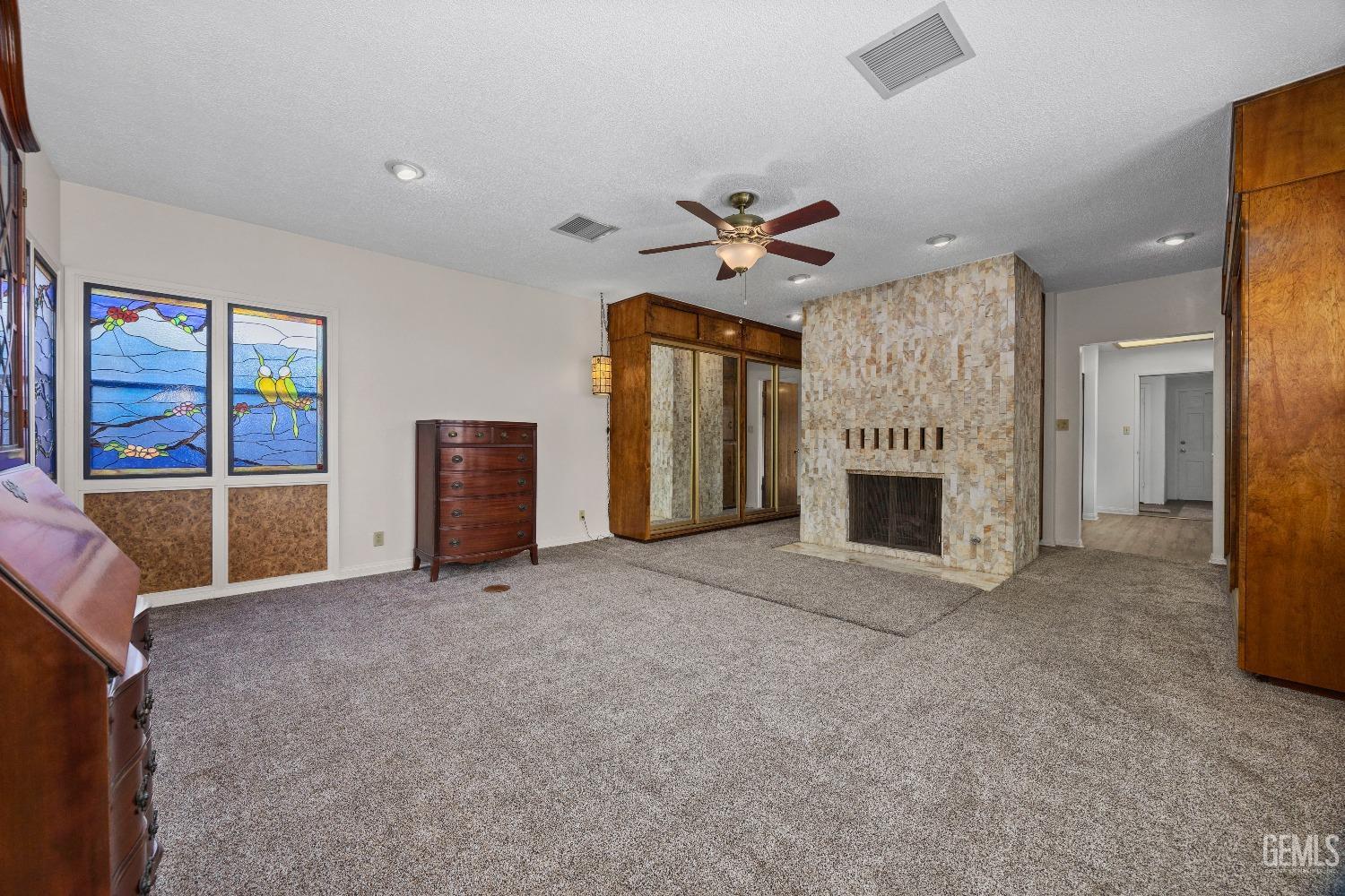 Undisclosed Address Bakersfield, CA 93308 - Photo 13 of 36 a view of a livingroom with an empty space and a fireplace