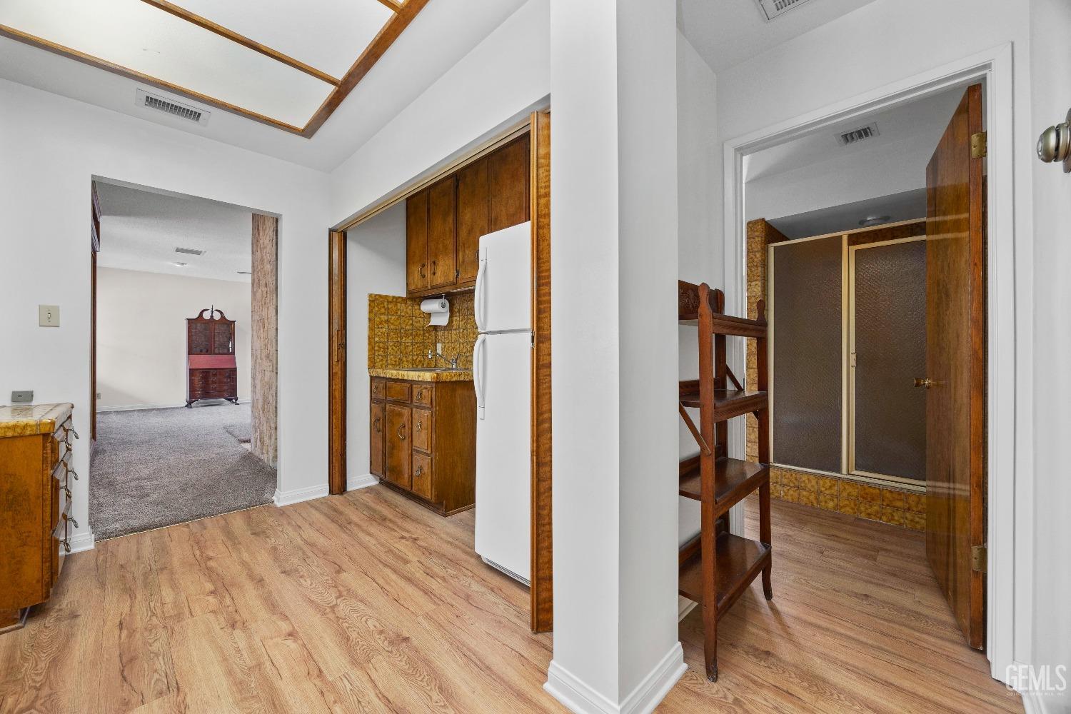 Undisclosed Address Bakersfield, CA 93308 - Photo 19 of 36 a view of a hallway with wooden floor and closet