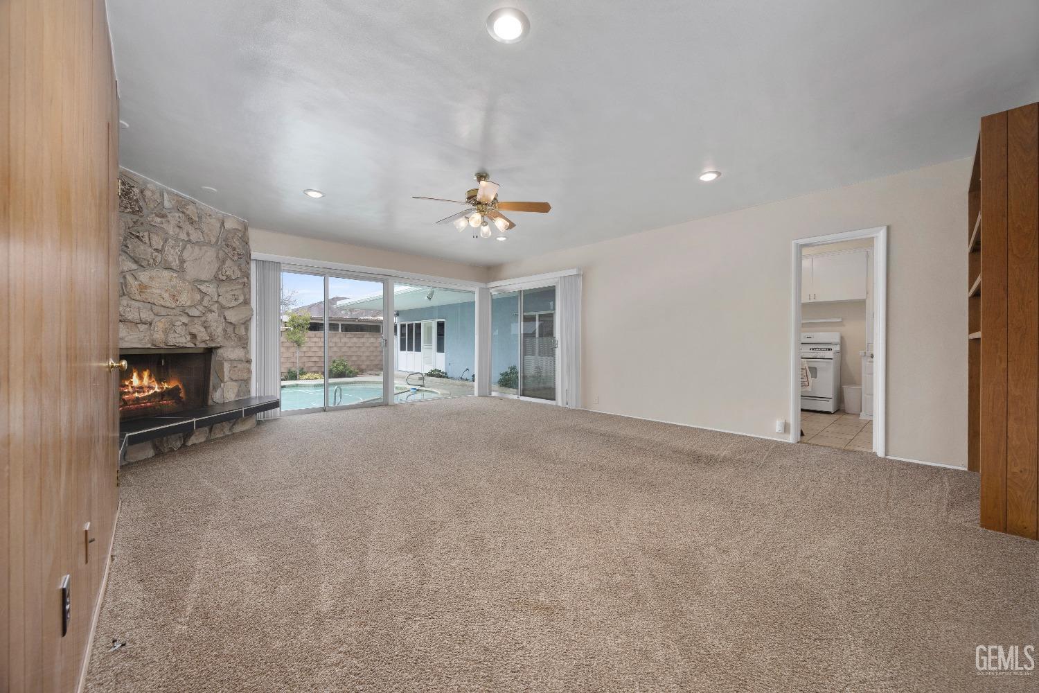 Undisclosed Address Bakersfield, CA 93308 - Photo 20 of 36 a view of an empty room with a fireplace and a window