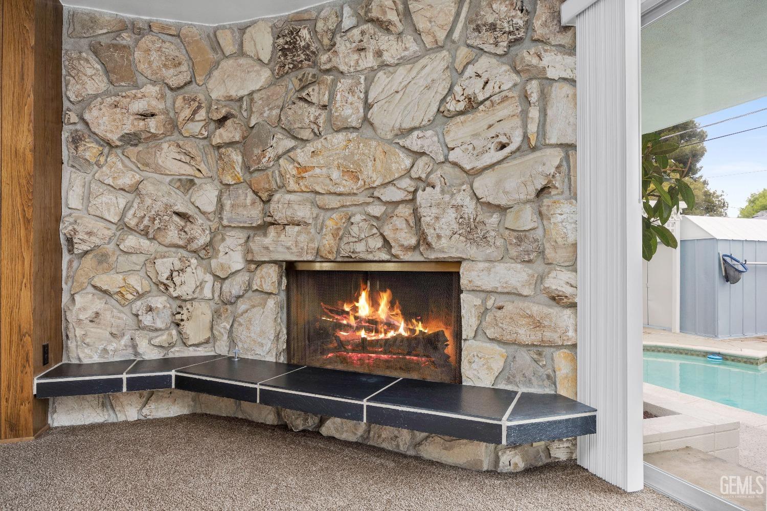 Undisclosed Address Bakersfield, CA 93308 - Photo 21 of 36 a living room with a fireplace and a flat screen tv