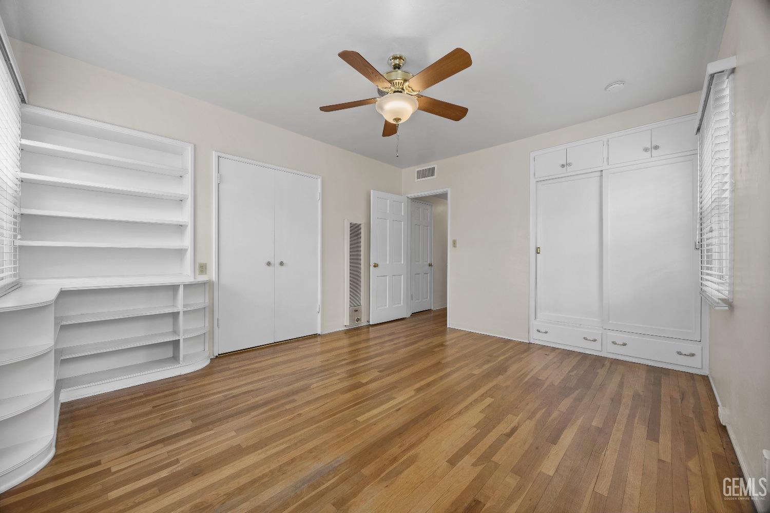 Undisclosed Address Bakersfield, CA 93308 - Photo 28 of 36 a view of an empty room with a window and wooden floor
