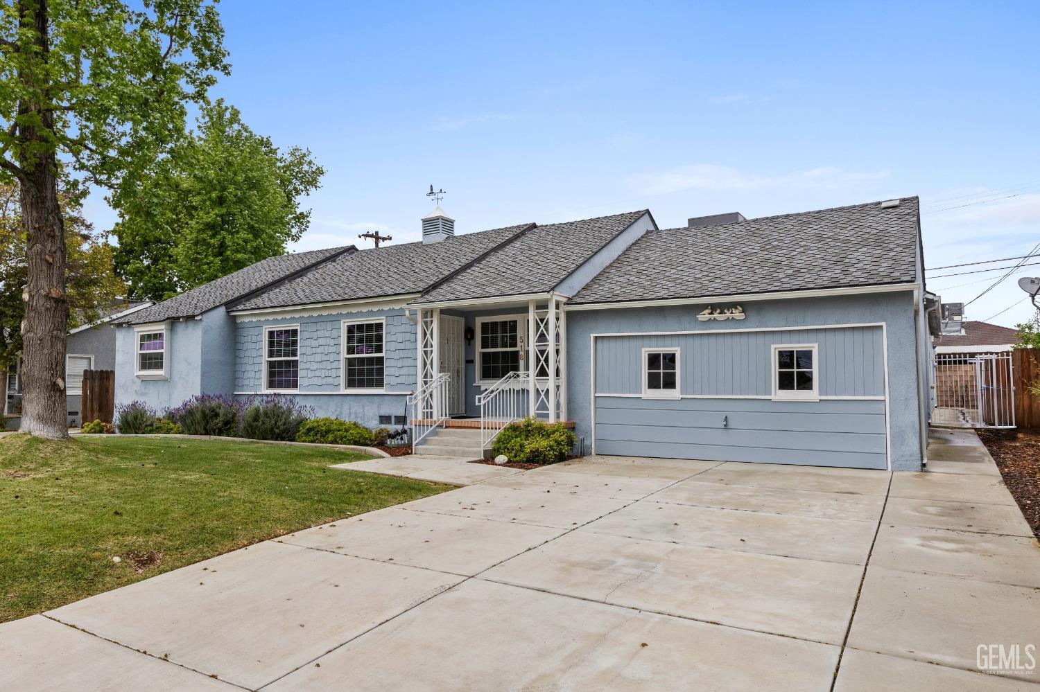 Undisclosed Address Bakersfield, CA 93308 - Photo 3 of 36 a front view of a house with a garden