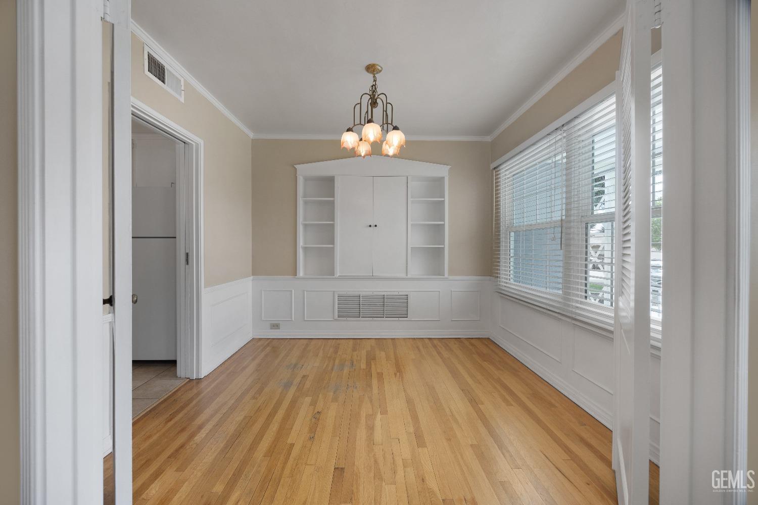 Undisclosed Address Bakersfield, CA 93308 - Photo 5 of 36 wooden floor in an empty room with a window