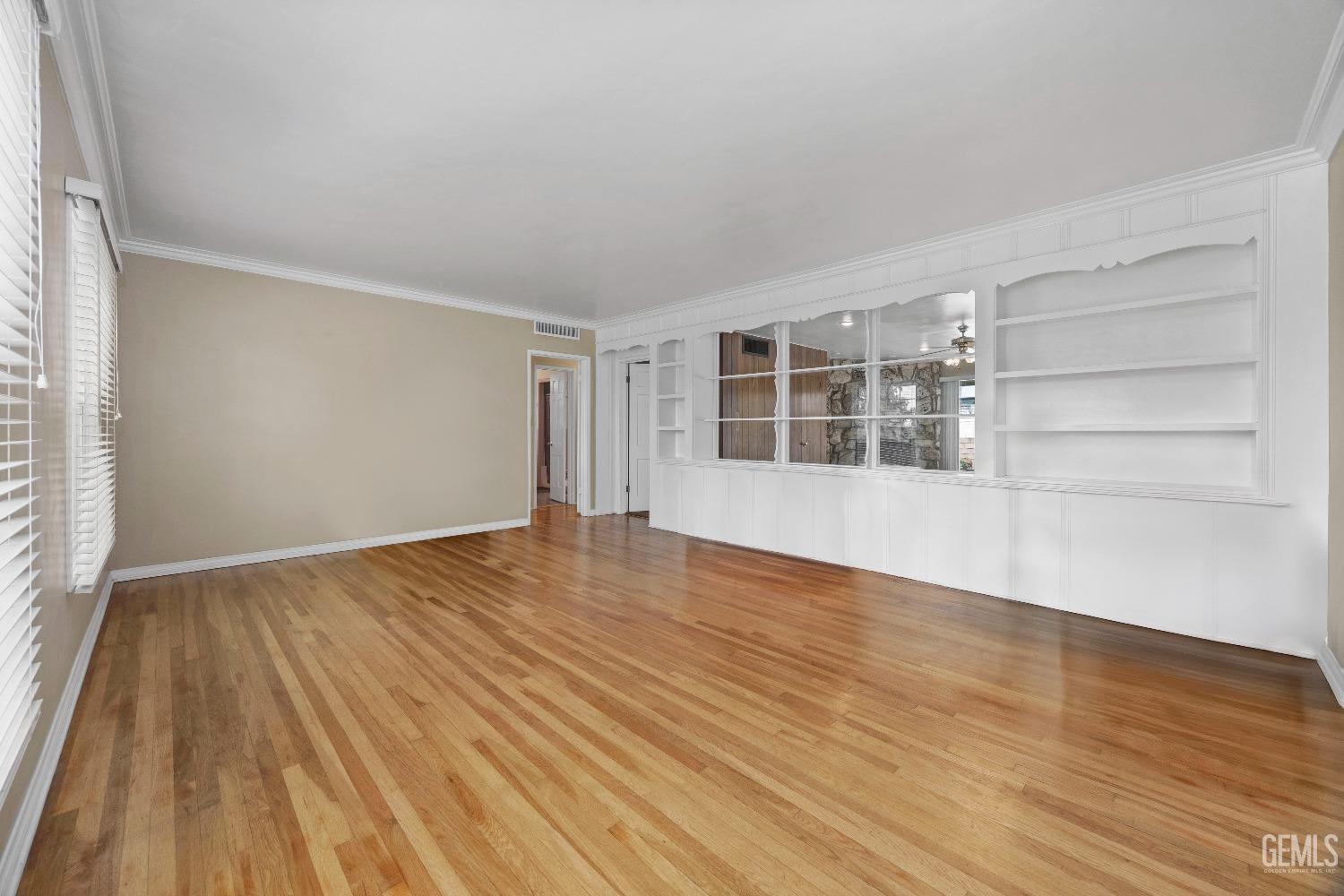 Undisclosed Address Bakersfield, CA 93308 - Photo 6 of 36 a view of empty room with wooden floor and windows
